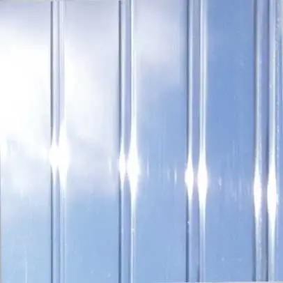 Close-up of ribbed, clear translucent sunroom roofing material reflecting a bright blue sky.
